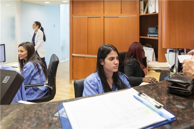 The Dental Options team at the front desk of the Aventura office